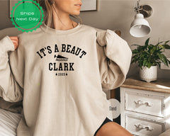 a woman wearing a sweatshirt that says it&#39;s a beauty clark