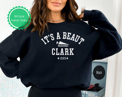 a woman wearing a sweatshirt that says it&#39;s a beauty clark